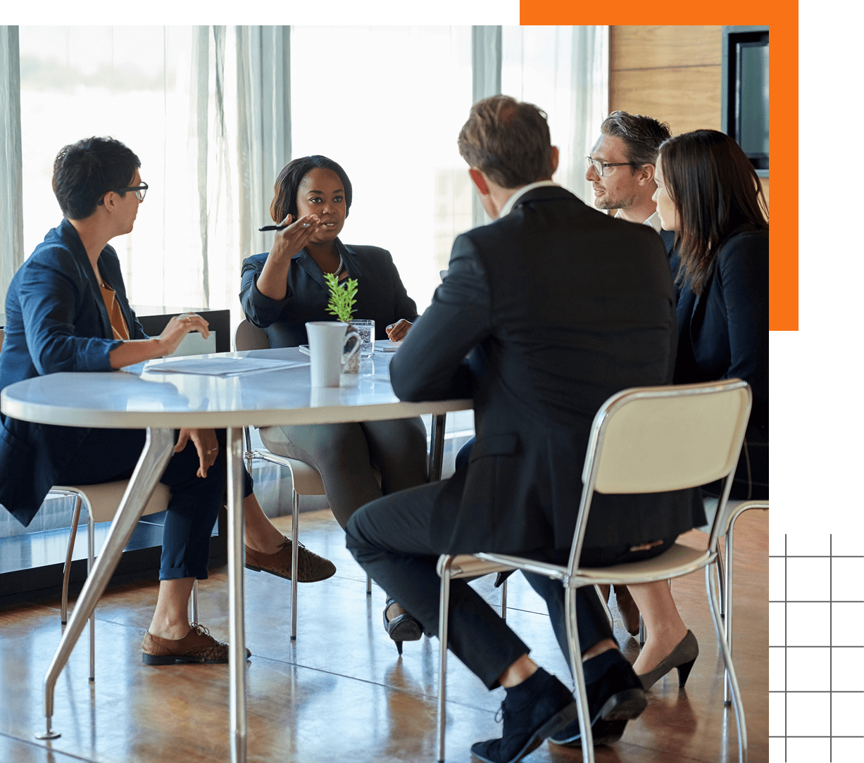 Business meeting with five people at table.